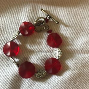 Bracelet. Silvertone charms with Red wave beads.